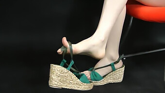 Asian Feet In Wedge Espadrille Sandals: A Close-Up View